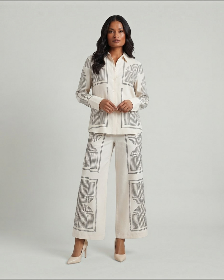 Luna Moda matching set featuring wide-leg trousers and a button-down shirt in cream with black geometric line art.