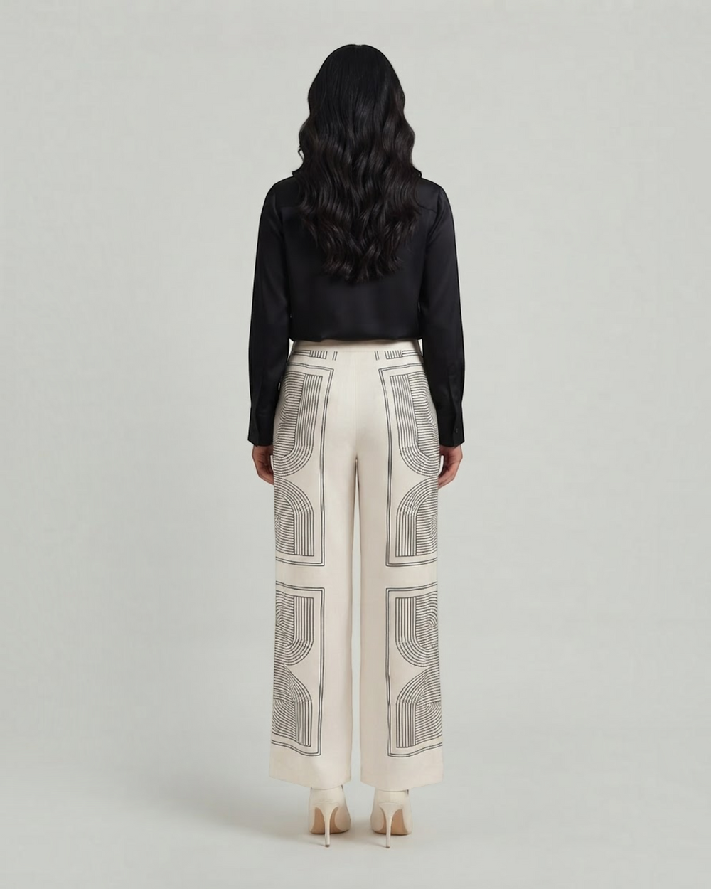 Luna Moda Demetra wide-leg trousers in cream with black geometric graphic print, back view on a model.