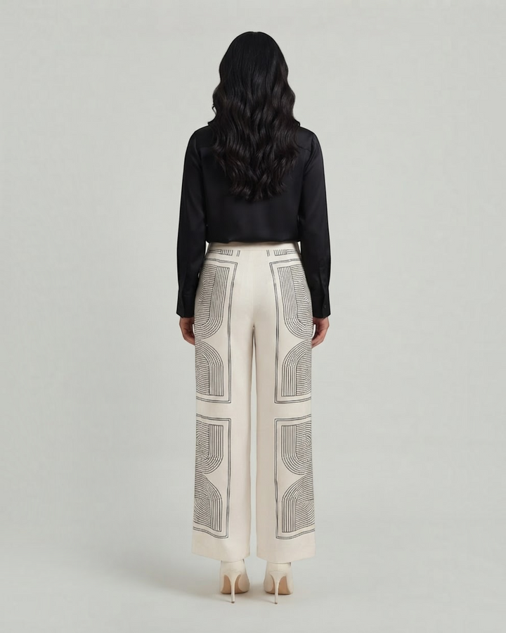 Luna Moda Demetra wide-leg trousers in cream with black geometric graphic print, back view on a model.
