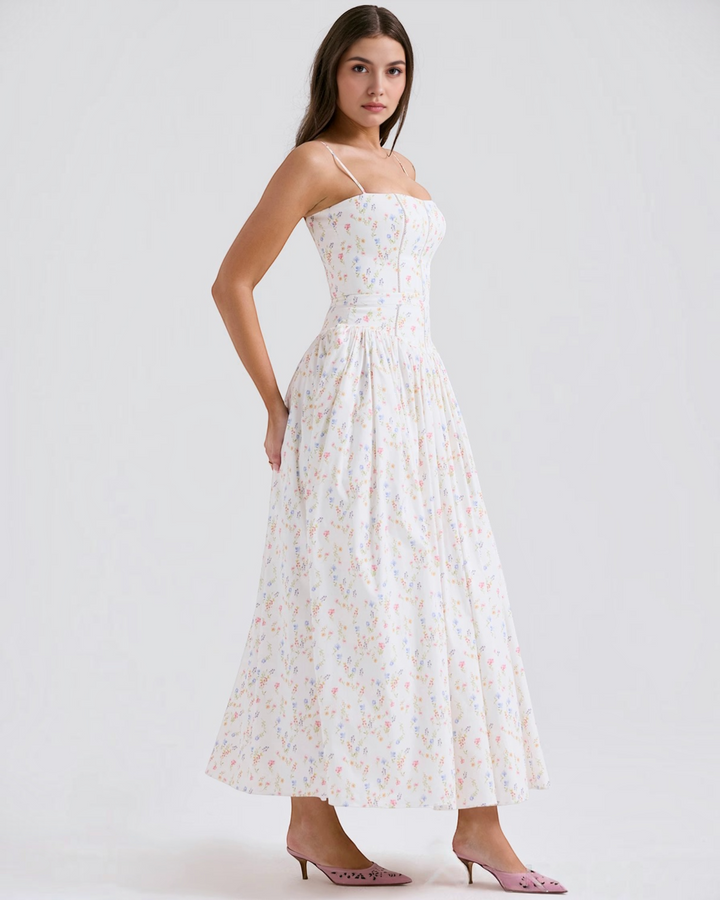 Luna Moda Violetta midi dress with a white floral print, fitted bodice, and spaghetti straps worn by a model