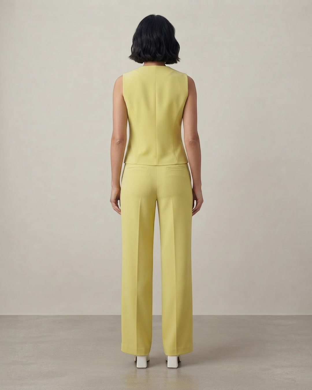 Luna Moda yellow sleeveless top and tailored trousers set worn by a woman, back view showing a sleek professional fit