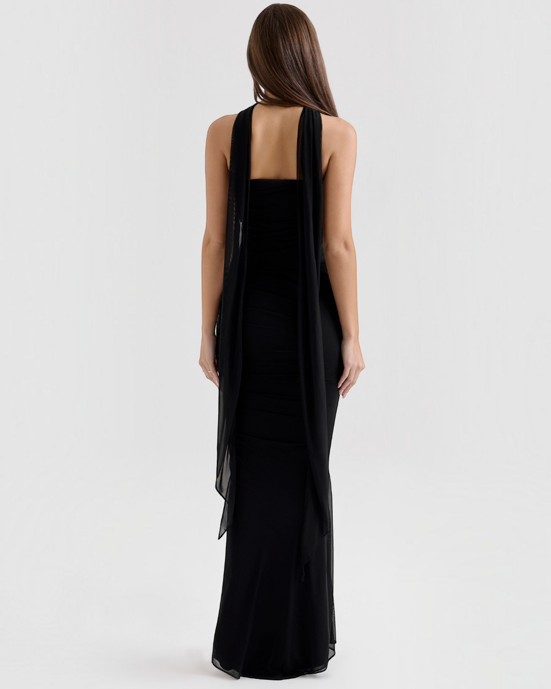 Luna Moda Seraphina black mesh corset dress with a long removable scarf, shown from the back on a model.