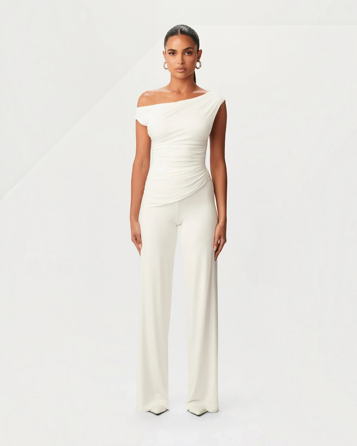 Luna Moda white asymmetric top and matching trousers set with side ruching on a model against a neutral background