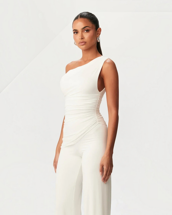 Luna Moda white asymmetrical one-shoulder top with side ruching worn by a model against a neutral background