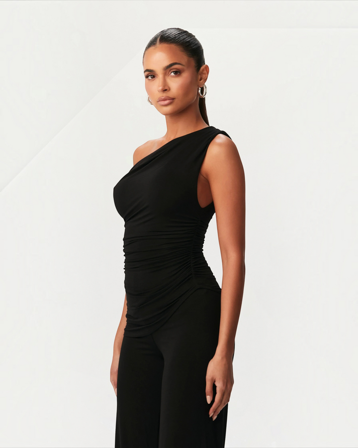 Luna Moda black asymmetric one-shoulder top with side ruching worn by a model against a neutral background