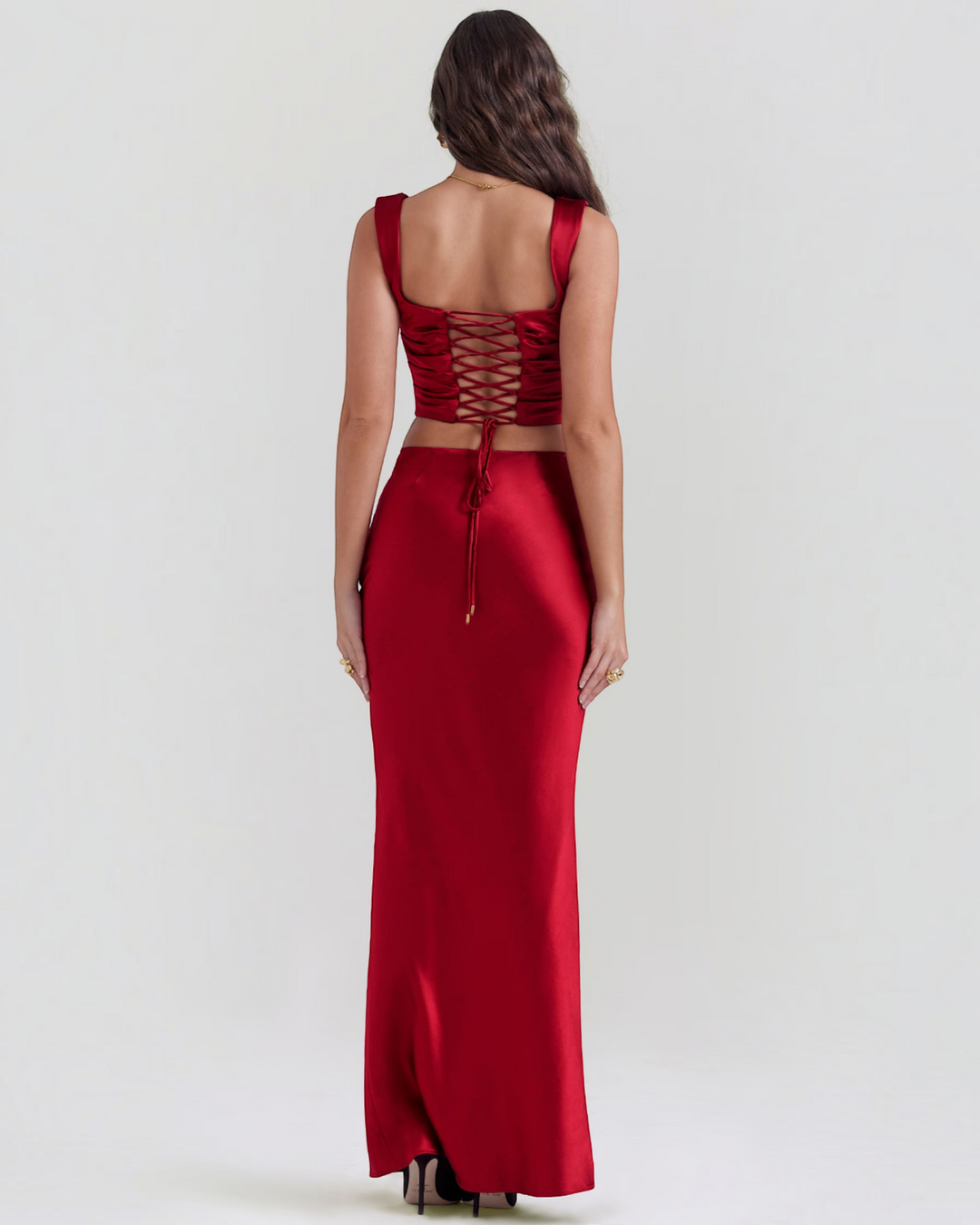 Luna Moda red satin corset top and matching maxi skirt set with lace-up back detail worn by a model from behind
