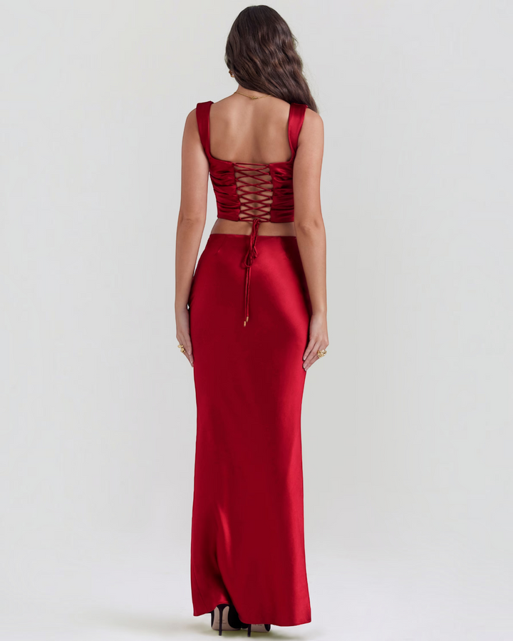 Luna Moda red satin corset top and matching maxi skirt set with lace-up back detail worn by a model from behind