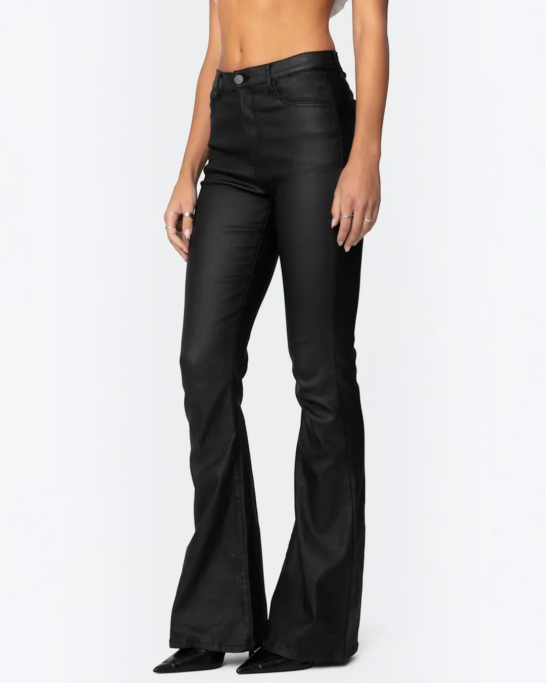 Luna Moda ELENA high-waisted black glossy flared trousers worn by a model, featuring a sleek and fitted silhouette.