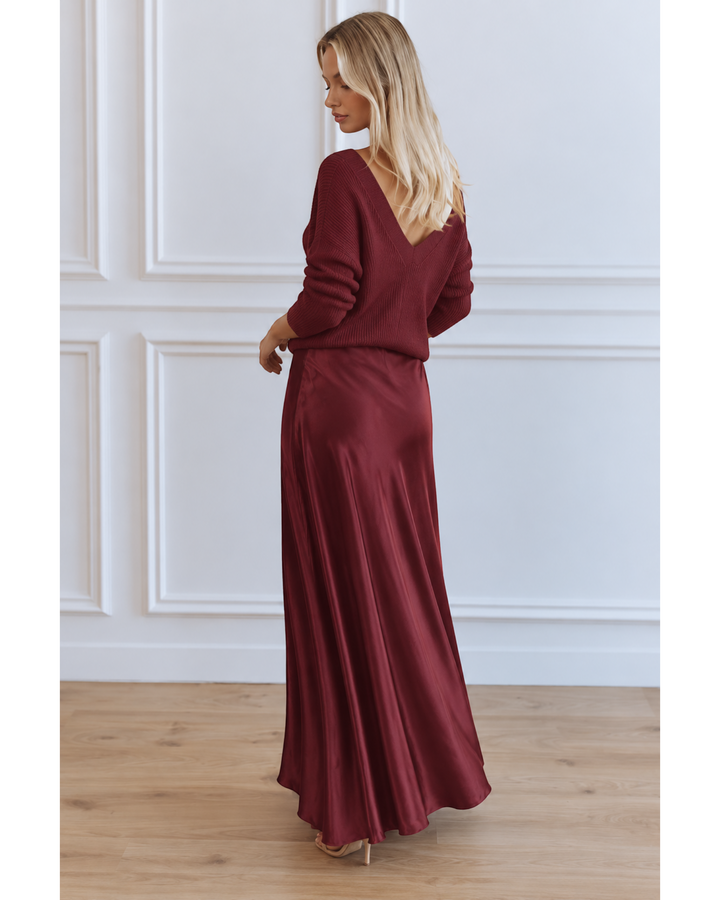 Luna Moda burgundy satin midi dress paired with a matching V-neck sweater, worn by a blonde model in a studio.