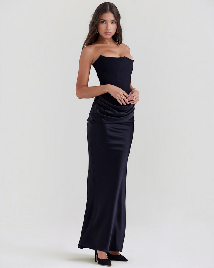 Luna Moda Leilani black strapless evening gown with a structured bodice and elegant side draping on a model.