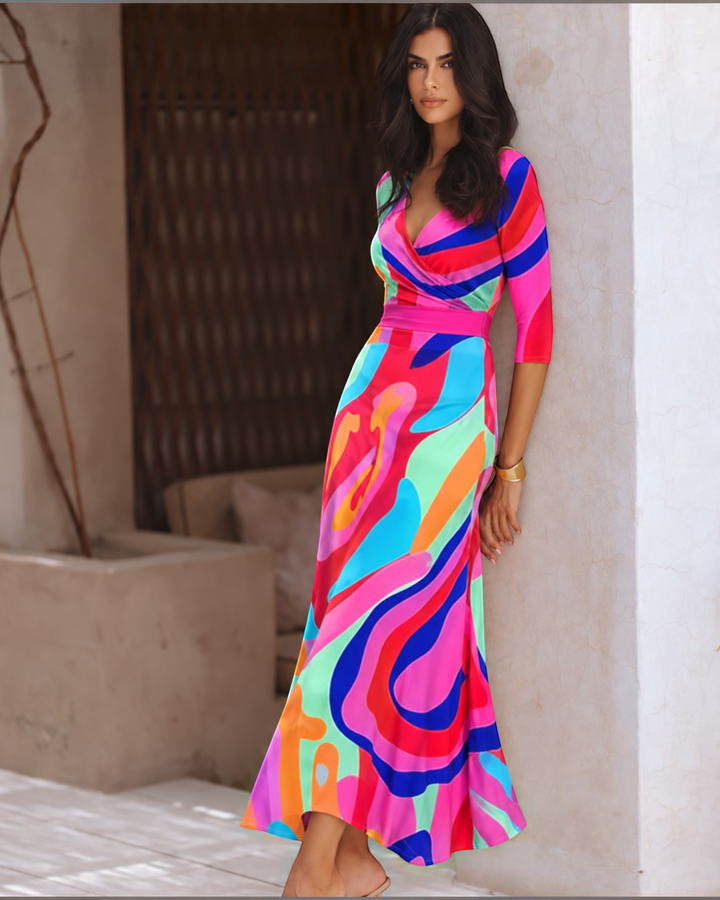 Luna Moda Emilia maxi dress with vibrant abstract floral print, V-neck, and fluid silhouette on a model.