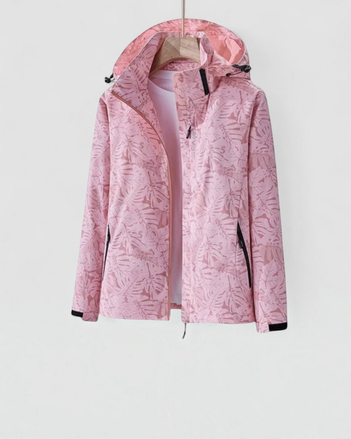 Luna Moda lightweight waterproof jacket in light pink with a tropical leaf print, featuring a hood and zip closure.