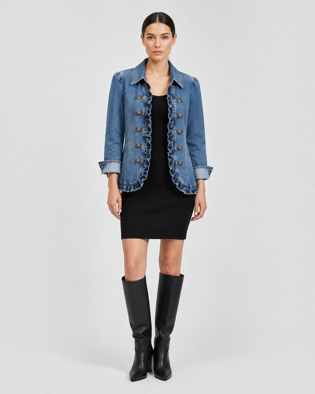 Luna Moda Fiorella denim jacket with ruffled edges, point collar, and antique buttons worn over a black dress.