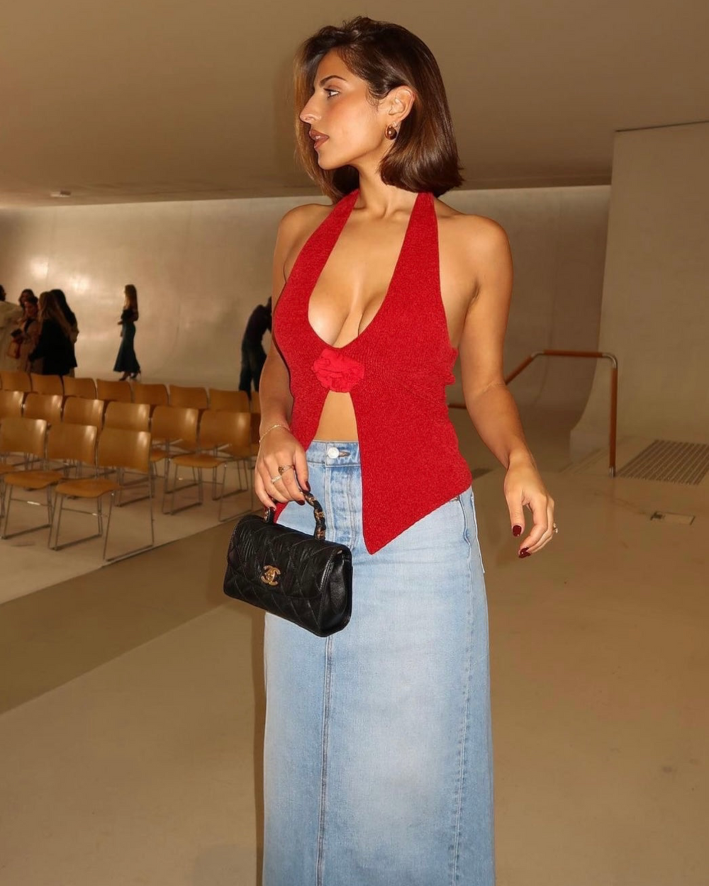 Luna Moda EVA pink halter top with a floral detail, worn with a light wash denim midi skirt and a black handbag.