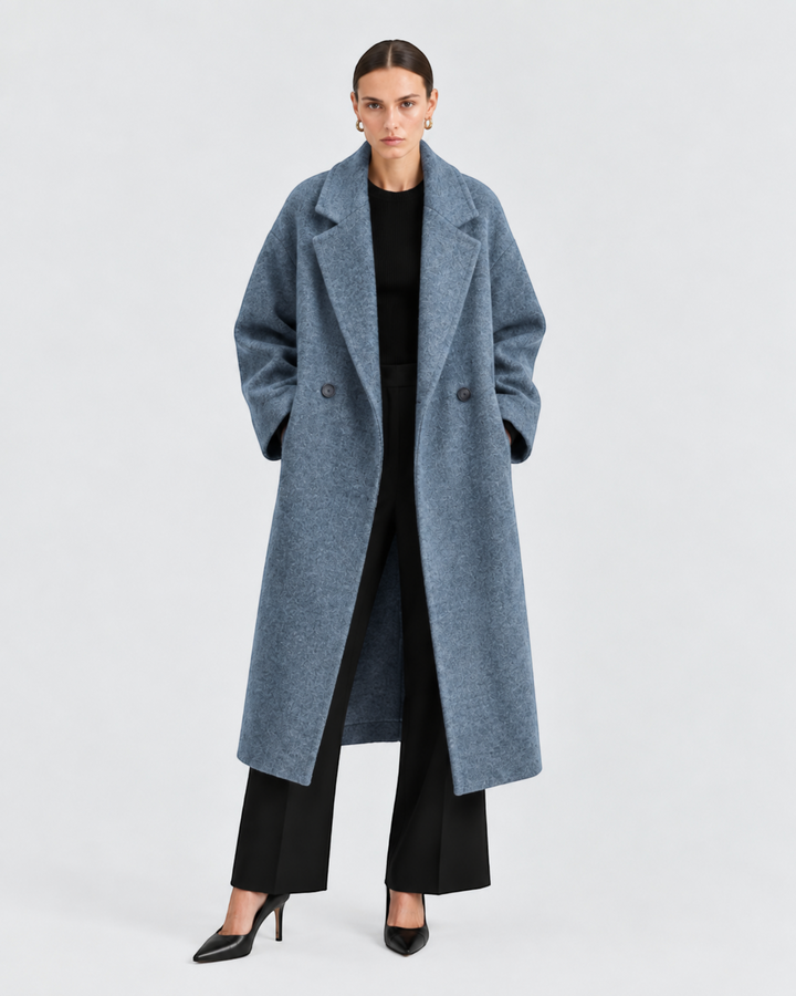 Luna Moda GENOVEFFA long blue wool coat with wide reversible collar and pockets worn by a model on a grey background