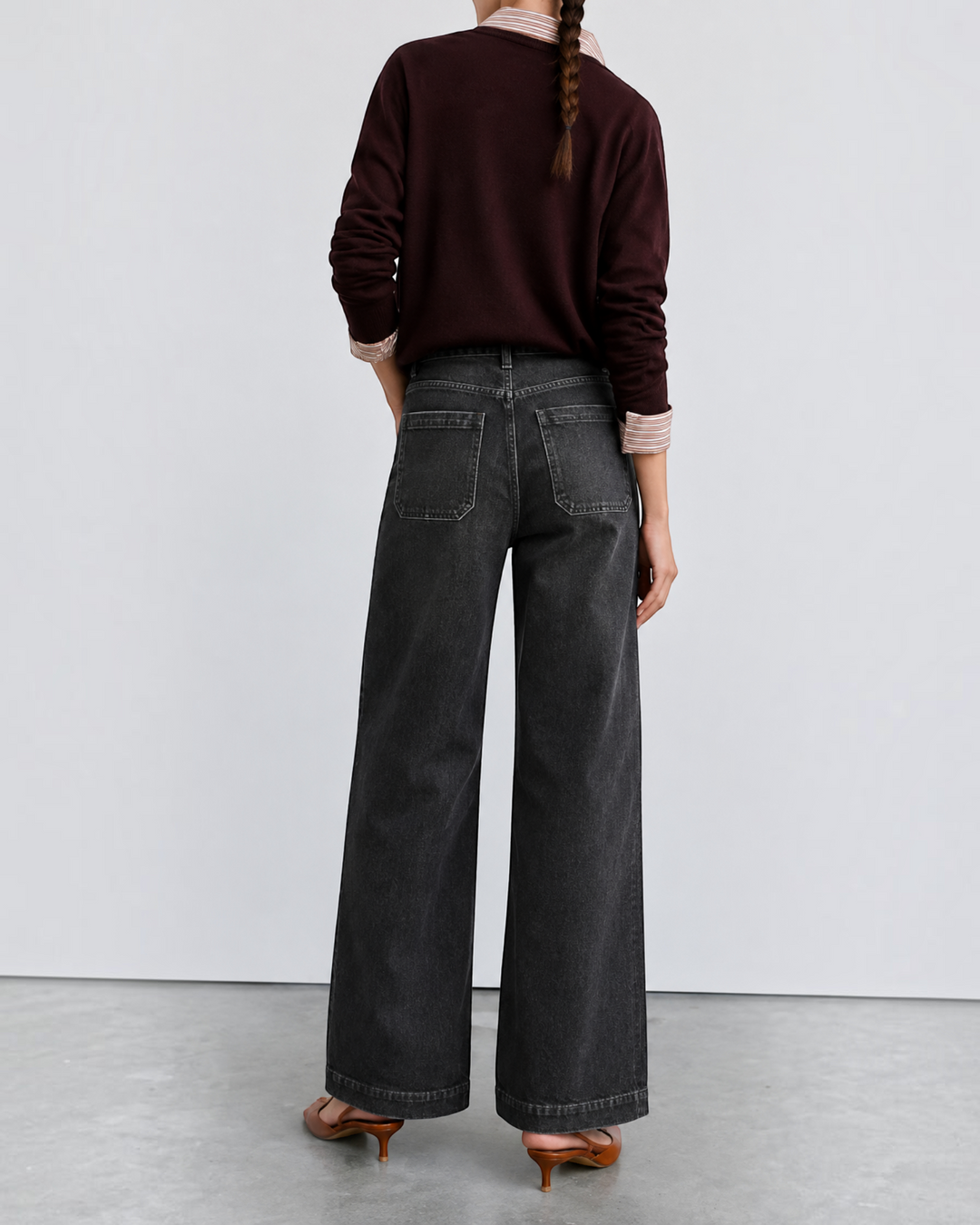 Luna Moda high-waisted dark wash retro jeans worn by a woman with a burgundy sweater, back view.