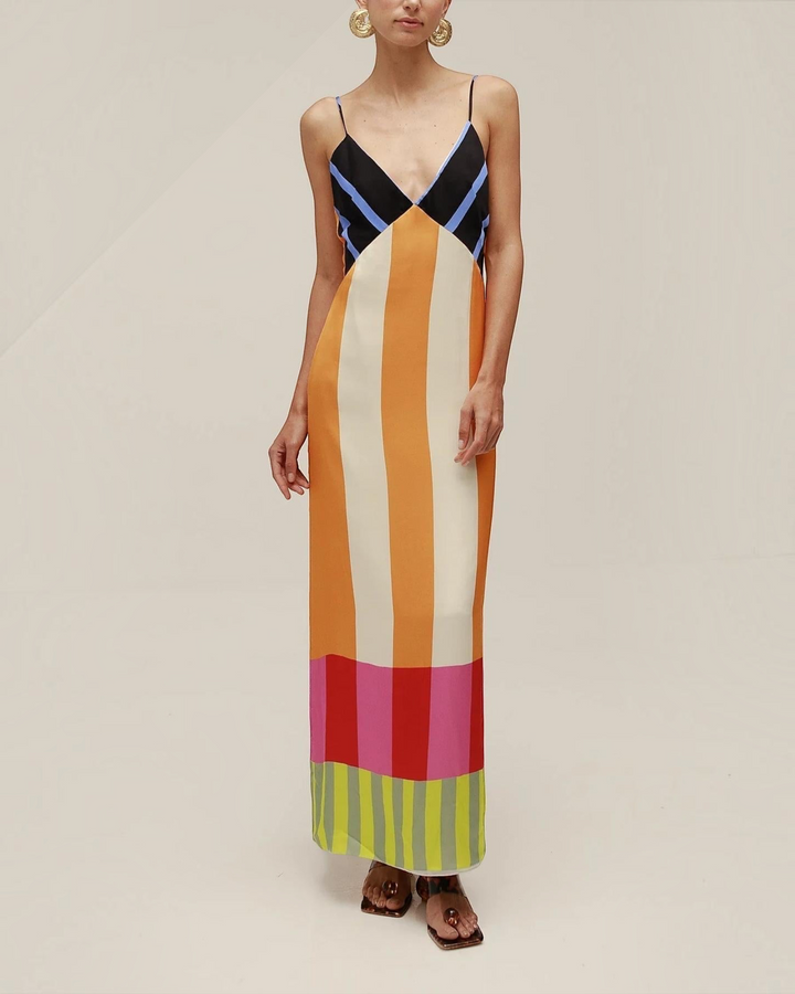 Luna Moda Paloma maxi dress with vibrant geometric stripes, spaghetti straps, and a fitted bodice on a model.