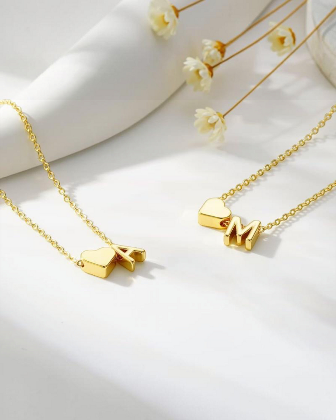 Luna Moda gold double chain bracelets featuring minimalist heart charms and personalized initial pendants