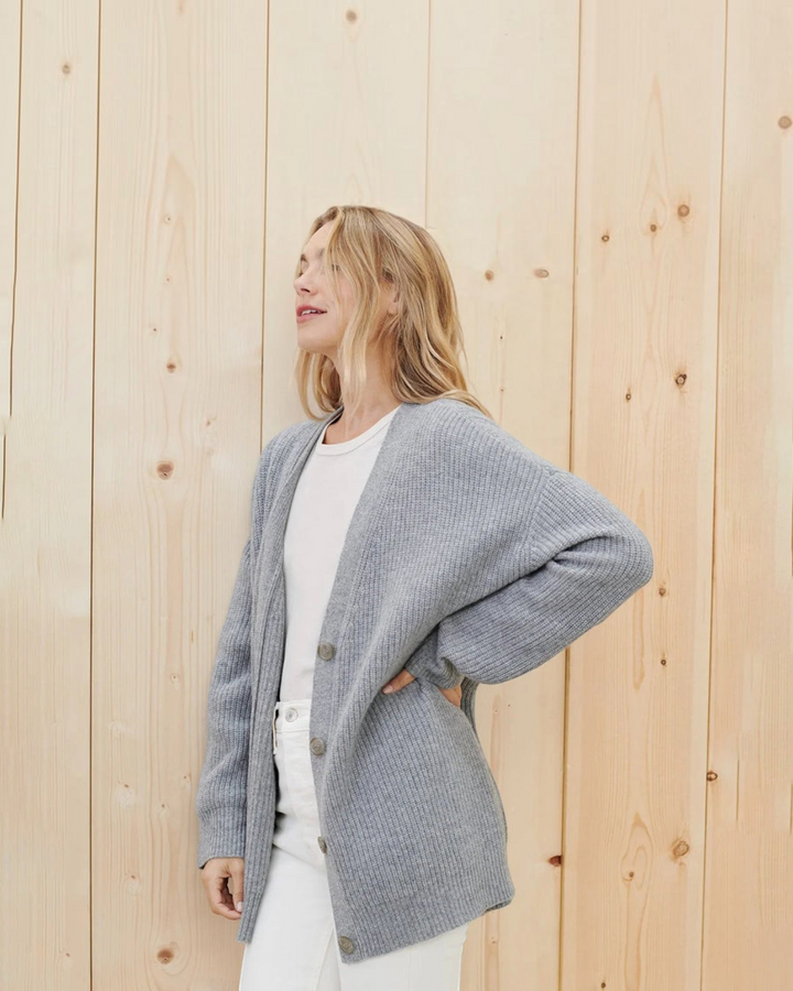 Luna Moda grey cashmere V-neck cardigan worn by a woman against a light wood background
