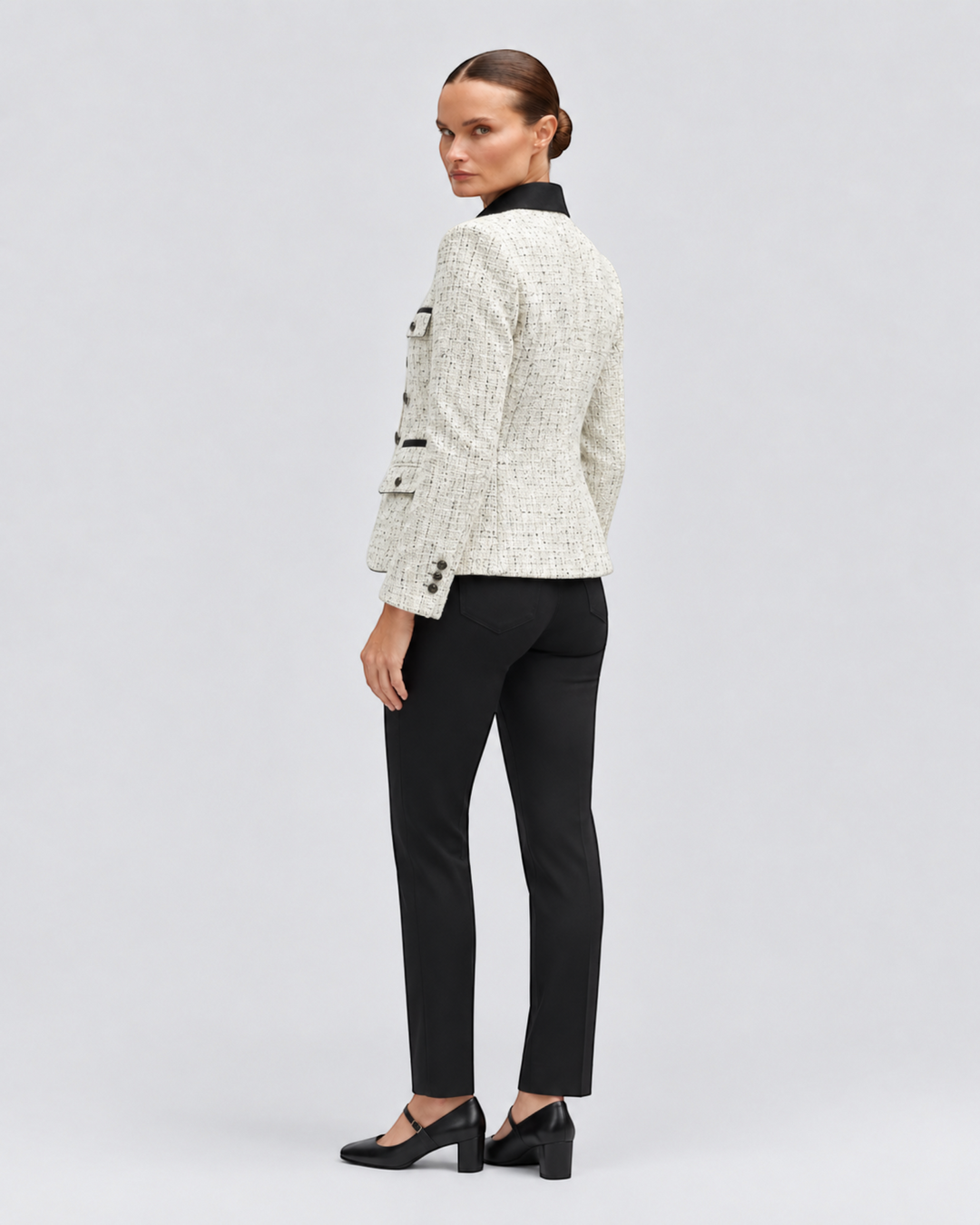 Luna Moda Ida tweed jacket in cream with a black contrast collar and button details, worn by a model from behind.