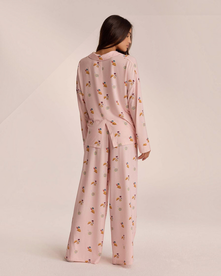 Luna Moda Mattine Dolci pink pajama set with breakfast print, button-up shirt and wide-leg trousers, back view.