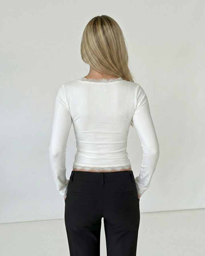 Luna Moda white long-sleeve top with square neckline and delicate lace trim on the collar and hem, back view.