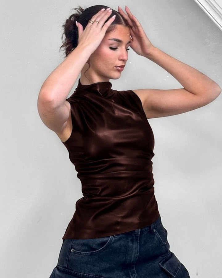 Luna Moda sleeveless brown faux leather top with a high neck and sculpted fit worn by a woman