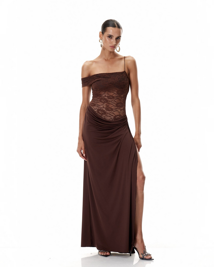 Luna Moda brown one-shoulder maxi dress with a semi-sheer lace bodice, draped skirt, and high thigh slit.