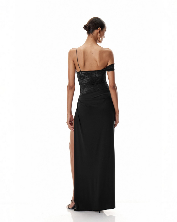 Luna Moda black one-shoulder maxi dress with lace bodice, draped skirt, and high thigh slit, back view