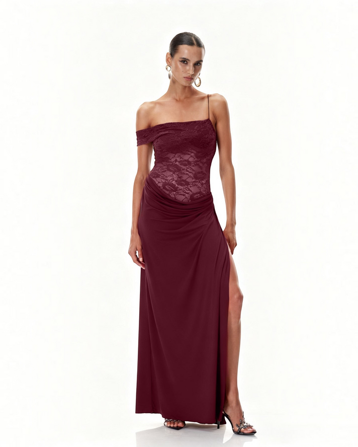 Luna Moda burgundy one-shoulder maxi dress with a semi-sheer lace bodice, draped skirt, and high thigh slit.