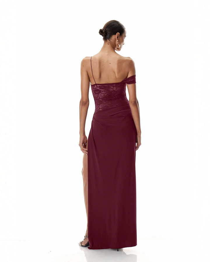 Luna Moda burgundy one-shoulder maxi dress with lace bodice, draped skirt, and high side slit, back view.