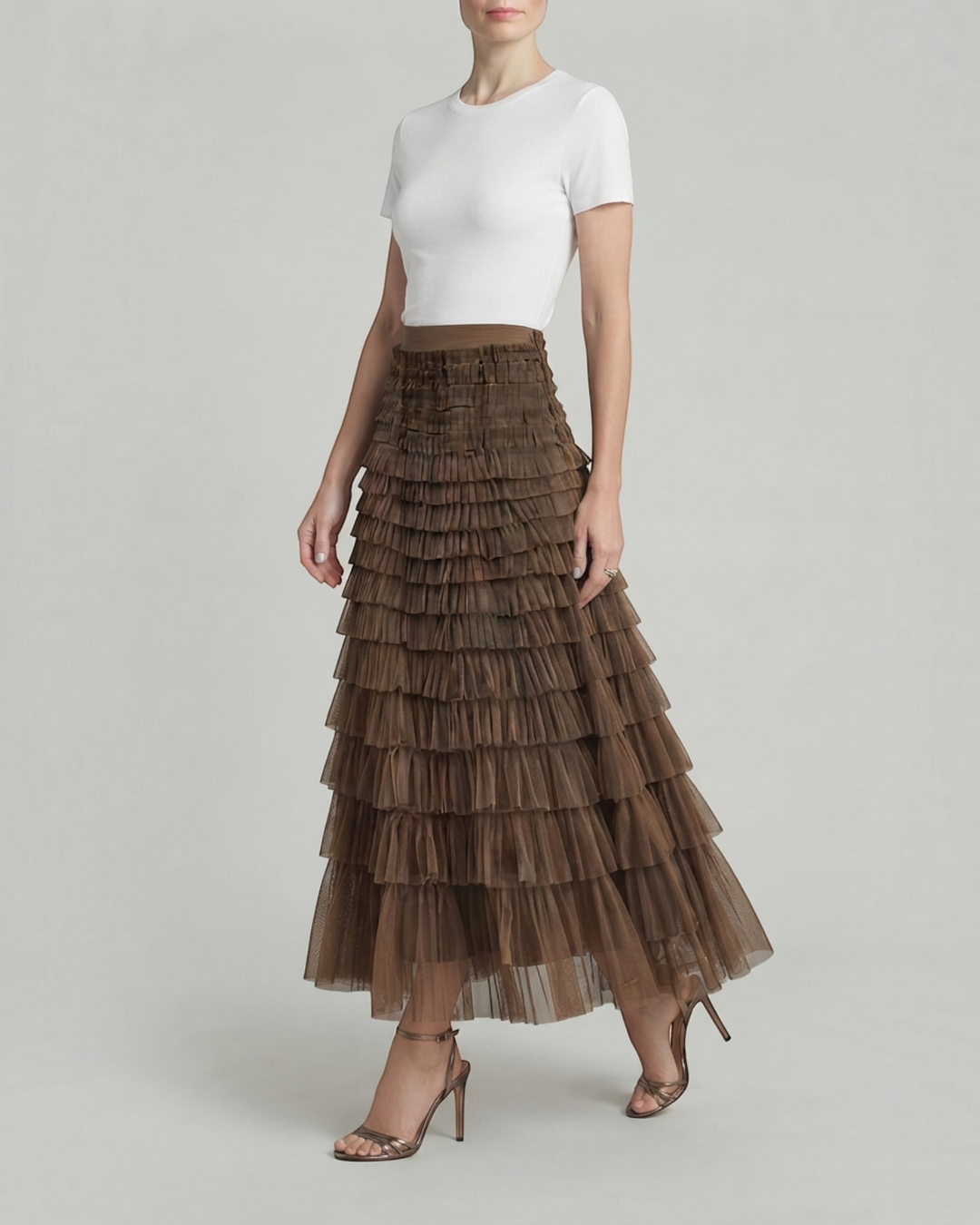 Luna Moda Inês maxi skirt in brown with layered ruffles and a satin finish worn with a white t-shirt and heels.