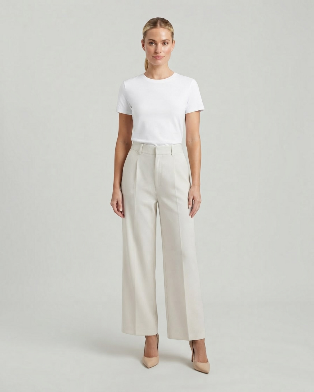 Luna Moda high-waisted beige palazzo trousers with a fluid pleated design worn with a white t-shirt and heels