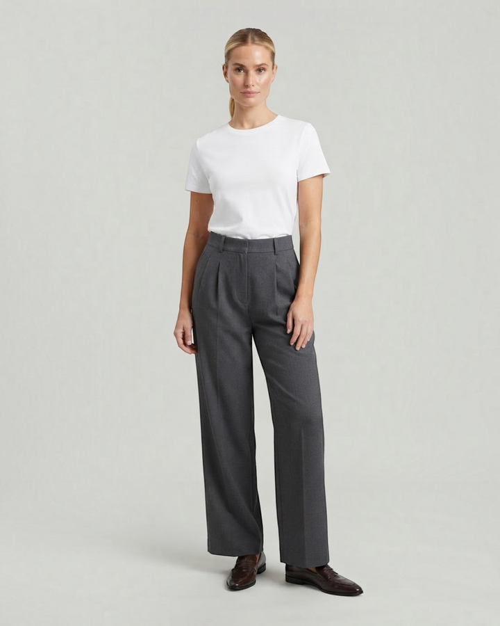 Model wearing Luna Moda high-waisted charcoal grey pleated palazzo trousers with a white t-shirt and loafers