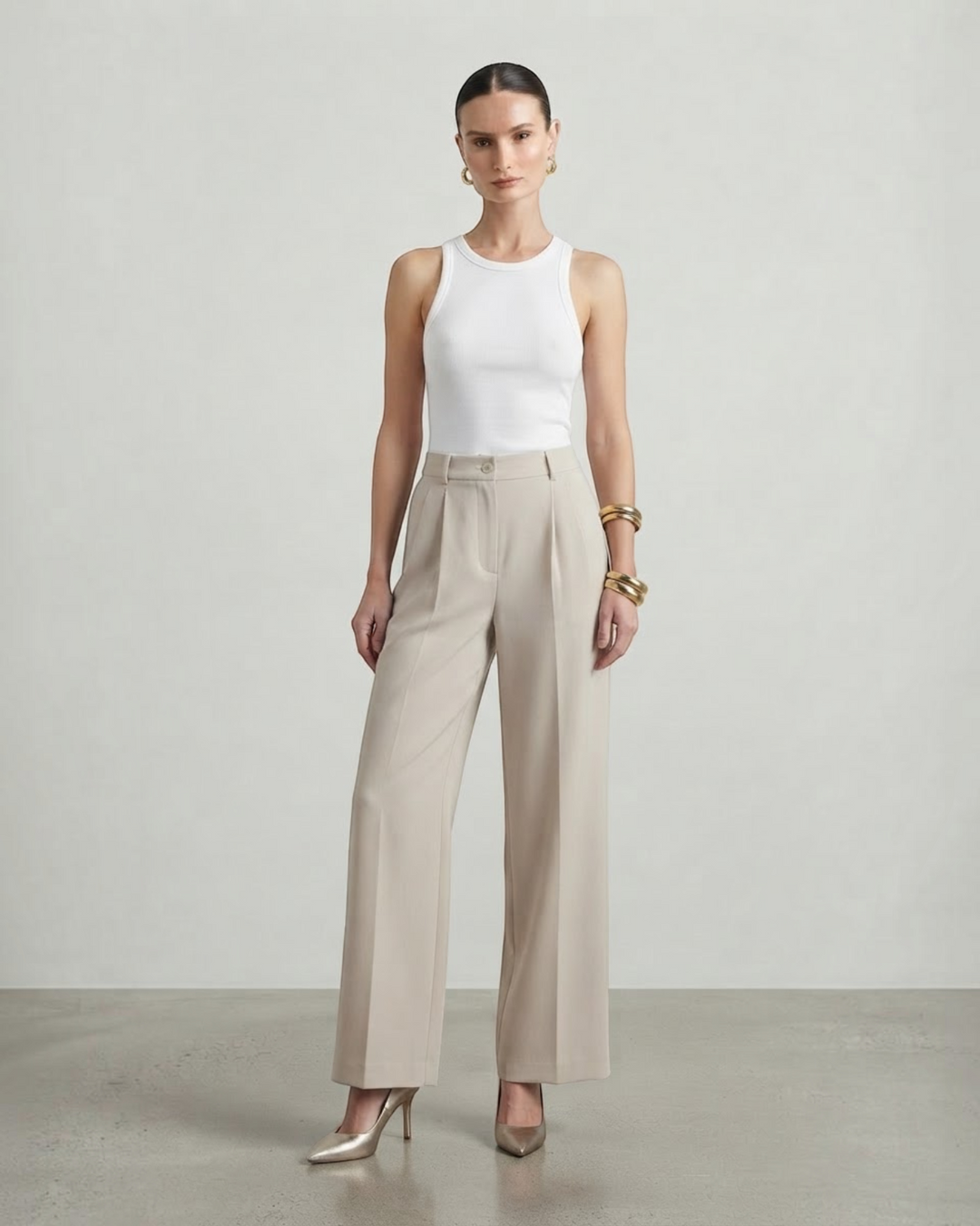 Luna Moda high-waisted beige palazzo trousers with a fluid wide-leg cut worn by a model with a white tank top