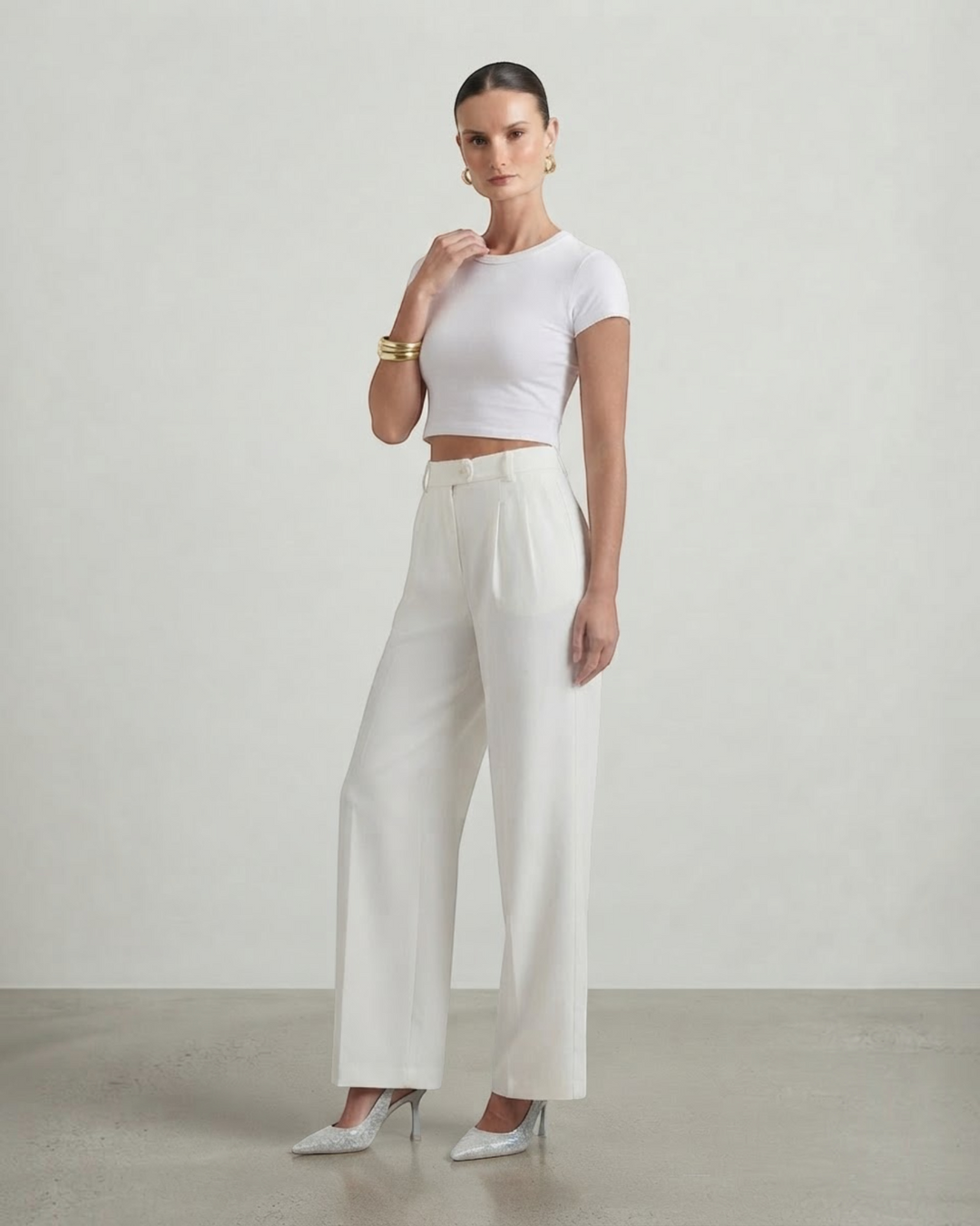 Luna Moda high-waisted white palazzo trousers paired with a white crop top on a model in a studio setting.