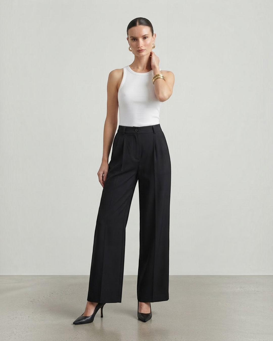 Luna Moda high-waisted black palazzo trousers with a fluid wide-leg fit worn by a model with a white tank top