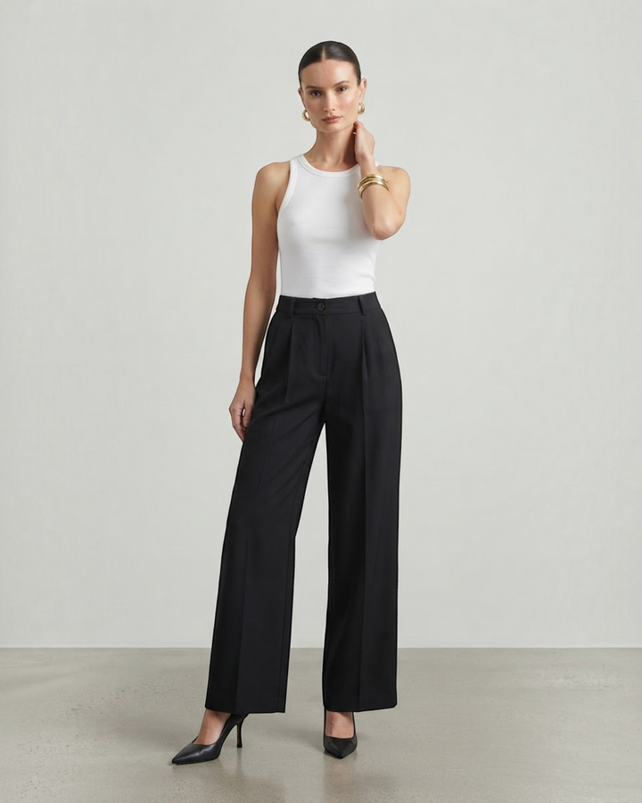 Luna Moda high-waisted black palazzo trousers with a fluid wide-leg fit worn by a model with a white tank top
