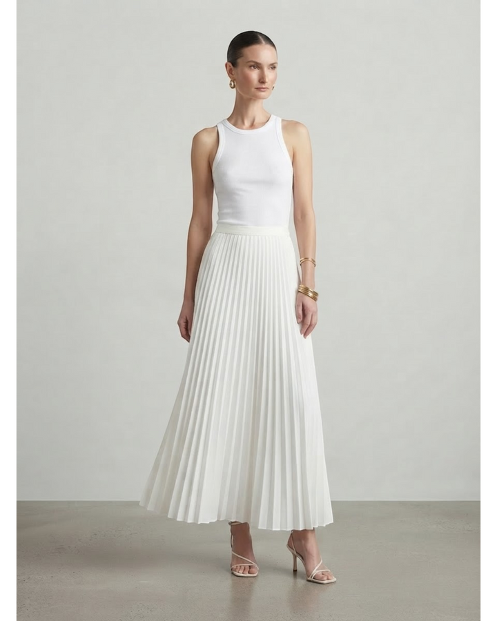 Luna Moda high-waisted white pleated maxi skirt paired with a sleeveless white tank top on a model