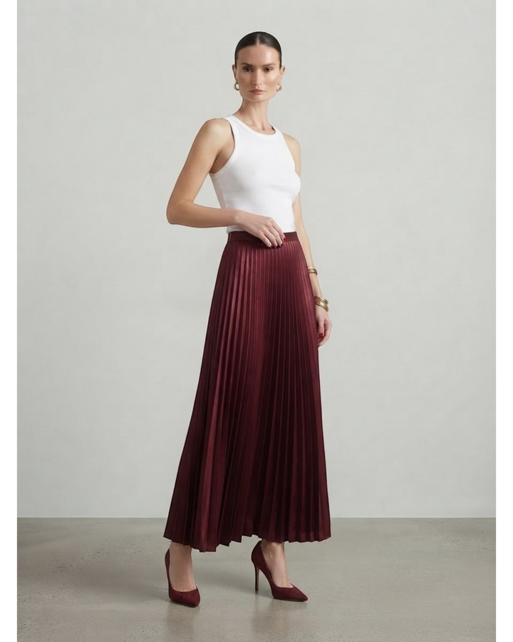 Luna Moda high-waisted burgundy pleated maxi skirt paired with a white tank top and matching heels