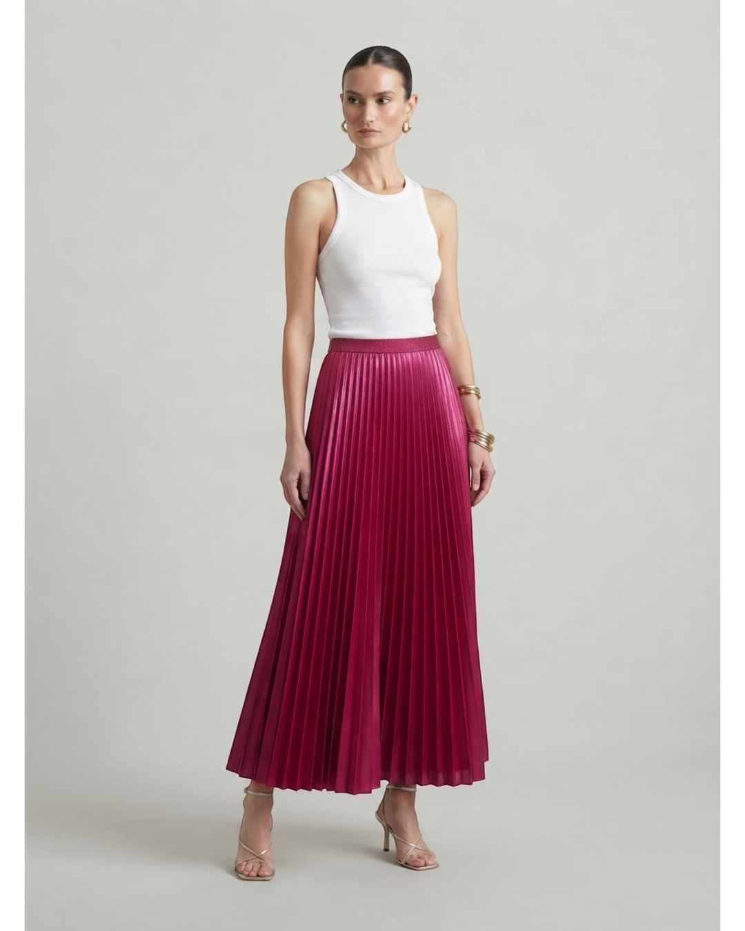 Luna Moda high-waisted magenta pleated maxi skirt worn with a white tank top and strappy heels on a model