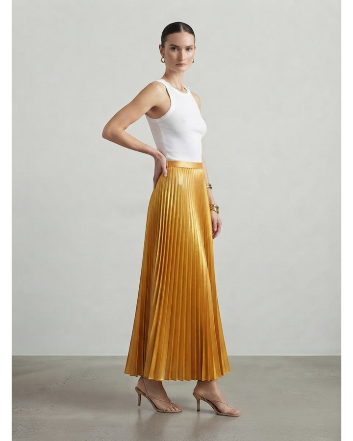 Luna Moda high-waisted metallic gold pleated maxi skirt worn by a model with a white tank top