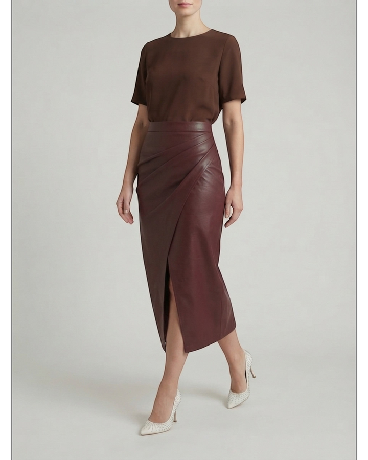 Luna Moda midi skirt in burgundy faux leather with draped front detail and a high front slit, worn with a brown top.