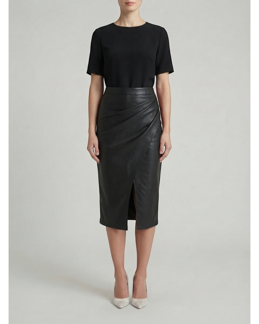 Luna Moda Natalie black midi skirt with draped design and front slit worn by a model with a black top