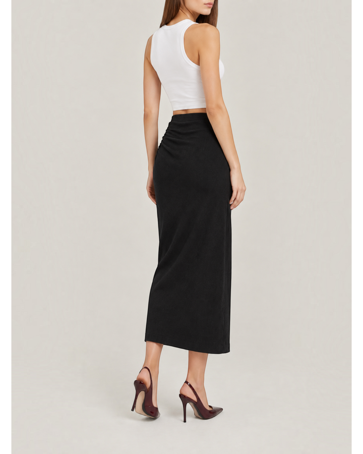 Luna Moda black midi skirt with side ruching worn by a model with a white tank top and dark high heels