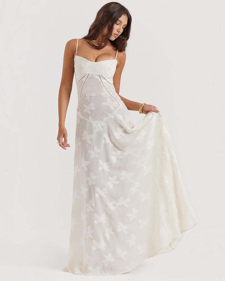 Luna Moda off-white maxi dress with butterfly embroidery, sweetheart neckline, and flowing skirt on a model