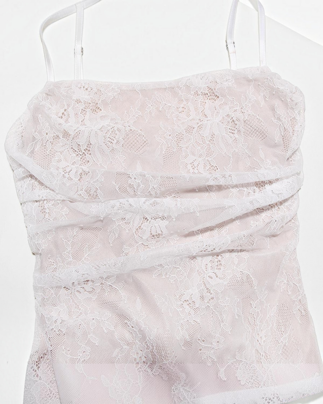 Luna Moda white lace maxi dress featuring a structured corset bodice with delicate floral patterns and spaghetti straps