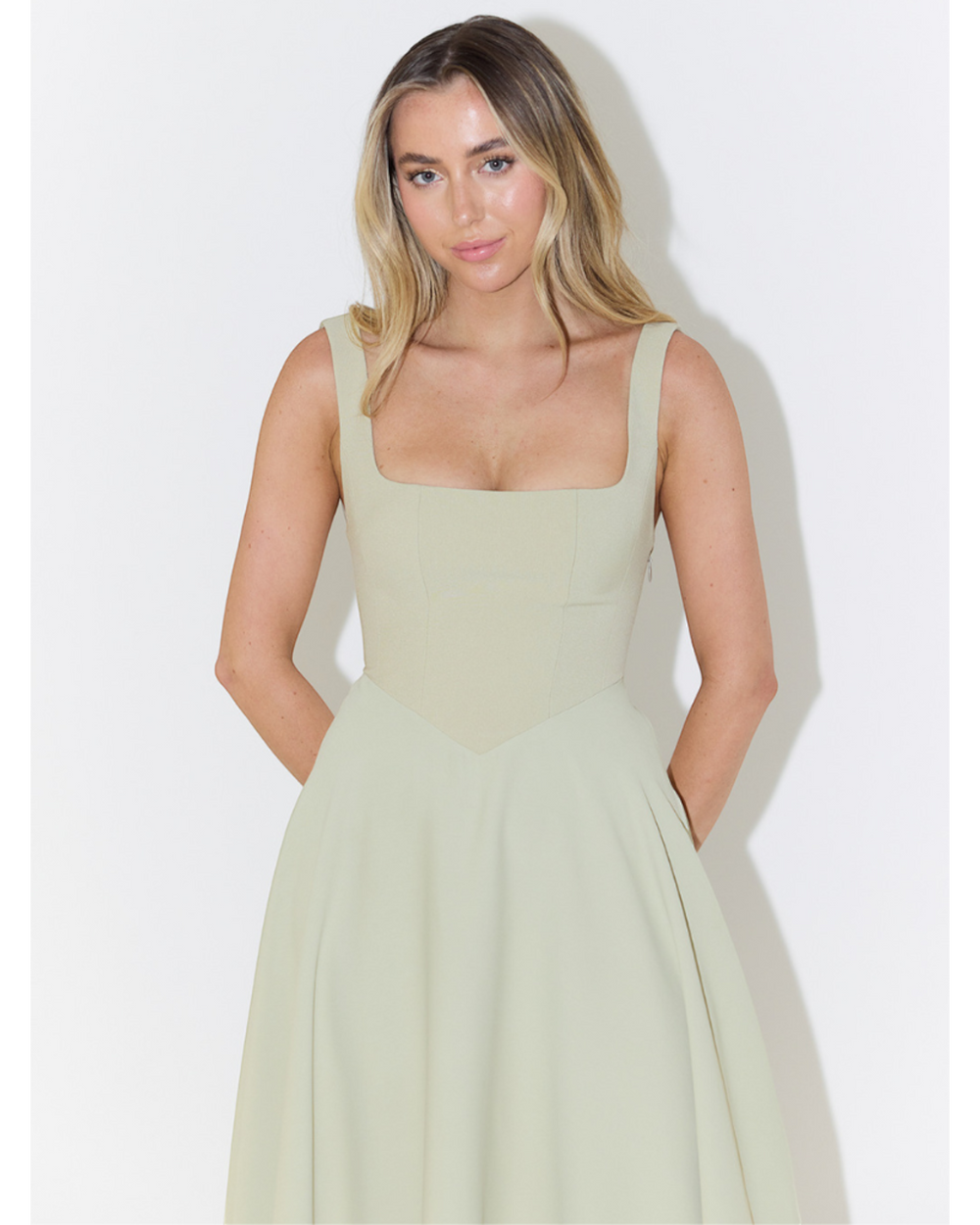 Luna Moda Scarlett Grace sage green midi dress with a square neckline and fitted bodice on a blonde model