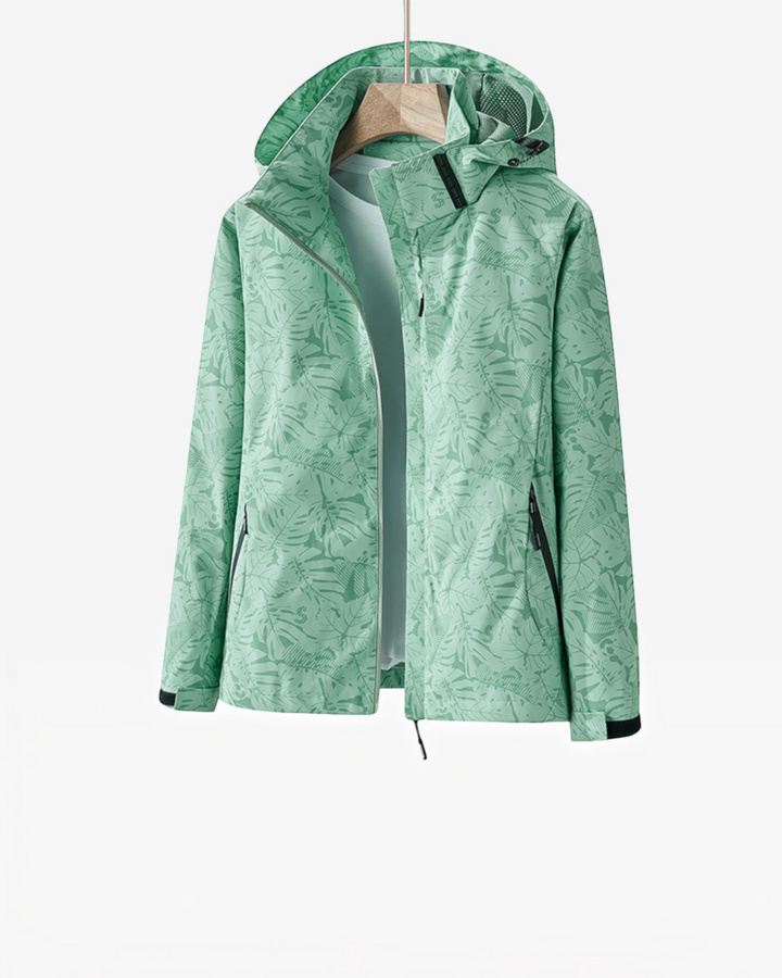Luna Moda lightweight waterproof hooded jacket in mint green with a tropical leaf print pattern on a hanger