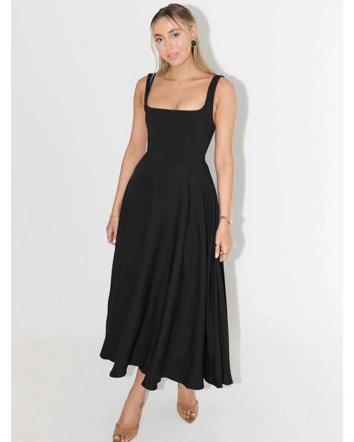Luna Moda Scarlett Grace black midi dress with a square neckline and flared skirt worn by a blonde model